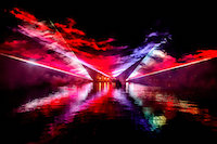 A photo taken during one of the most demanding shows because all the equipment was located on an island in the middle of the lake and the only way to smoke the area between the lasers and spectators was to place technicians and smoke generators on the boats. The boats did not have engines, so during the 17-minute spectacle the technicians had a lot of work with rowing.
